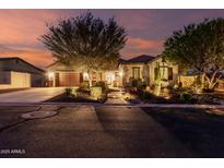Charming home with a well-manicured front yard and cozy curb appeal at twilight at 12725 W Forest Pleasant Pl, Peoria, AZ 85383