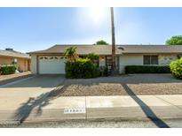 Charming single-story home with a well-maintained front yard, attached garage and desert landscaping at 18842 N Lakeforest Dr, Sun City, AZ 85373