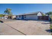 Charming home featuring desert landscaping, a spacious driveway, and an attached two-car garage at 19849 N 33Rd Ave, Phoenix, AZ 85027