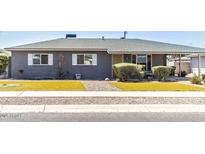 Charming single-story home with manicured front yard and mature landscaping at 2715 E Edgemont Ave, Phoenix, AZ 85008