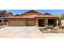 Charming single-story home with a three-car garage, desert landscaping, and a tile roof at 3028 W Parkside Ln, Phoenix, AZ 85027