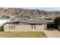 Ranch style home featuring block wall, flat roof and low maintenance landscaping at 327 E Monte Way, Phoenix, AZ 85042