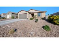 Charming single-story home featuring desert landscaping and a two-car garage, bathed in bright sunlight against a clear blue sky at 36515 N Takota Trl, San Tan Valley, AZ 85140