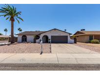 Single-story home with a well-maintained front yard, desert landscaping, and a two-car garage at 3765 W Wood Dr, Phoenix, AZ 85029