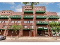 Attractive brick building featuring green balconies and awning, providing a stylish urban living experience at 424 S 2Nd St # 306, Phoenix, AZ 85004