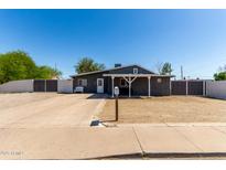 Charming single-story home featuring a covered porch, desert landscaping and a long driveway at 511 E Purdue Ave, Phoenix, AZ 85020