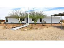 Charming single-story home with desert landscaping and mature trees in a rural setting at 53404 W Candlelight Rd, Maricopa, AZ 85139