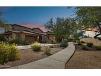 Charming single-Gathering home with desert landscaping, private garage, and well-lit entrance at sunset at 7221 E Eclipse Dr, Scottsdale, AZ 85266