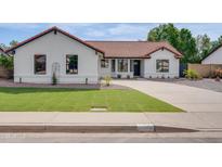 Charming single-story home featuring a well-manicured lawn, neutral exterior paint, and concrete driveway at 743 N Bermuda --, Mesa, AZ 85205