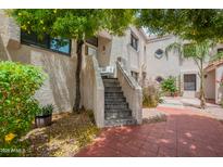 Inviting exterior view with a quaint patio, lush greenery, and textured walls giving curb appeal at 7800 E Lincoln Dr # 2029, Scottsdale, AZ 85250