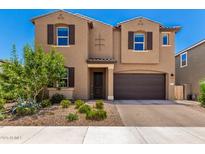 Two-story home featuring a desert landscape, tan stucco and a two car garage in a sunny neighborhood at 9837 E Satellite Dr, Mesa, AZ 85212