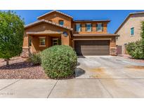 Inviting two-story home featuring a well-maintained yard and a spacious two-car garage at 12128 W Range Mule Dr, Peoria, AZ 85383