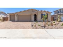 Charming single-story home featuring a three-car garage and a well-maintained, xeriscaped front yard at 12389 W Marguerite Ave, Avondale, AZ 85323