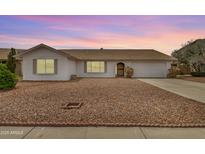 Charming single-story home boasting a low-maintenance landscape and a welcoming facade during dusk at 1245 W Lobo Ave, Mesa, AZ 85202