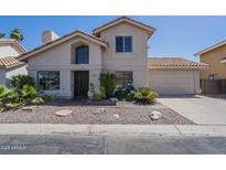 Charming two-story home with a desert landscaped front yard, tile roof and two car garage at 1320 N Brittany Ln, Gilbert, AZ 85233