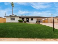 Charming single-story home with well-manicured lawn and carport in a sunny neighborhood at 1515 N Saguaro Dr, Tempe, AZ 85288