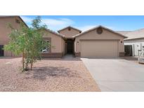 Inviting home featuring a well-kept front yard, desert landscaping, and attached two-car garage at 1623 E Leaf Rd, San Tan Valley, AZ 85140