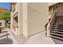 View of the exterior of the building with stairs leading up to the units at 1880 E Morten Ave # 125, Phoenix, AZ 85020