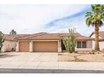 Charming single-story home boasts a well-maintained landscape, tile roof, and a spacious three-car garage at 4020 W Menadota Dr, Glendale, AZ 85308