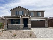 Charming two-story home featuring stone accents, a two car garage, and a well-manicured front yard at 40531 W Rio Grande Dr, Maricopa, AZ 85138