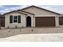 Charming single-story home featuring a brick-paved driveway, desert landscaping, and a dark brown garage door at 40559 W Rio Grande Dr, Maricopa, AZ 85138