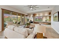 Open living room features a modern fireplace and stacked stone accents, perfect for entertaining and relaxing at 5626 E Sleepy Ranch Rd, Cave Creek, AZ 85331