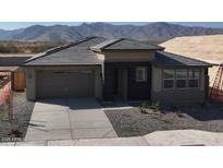 Charming single-story home with desert landscaping, a two-car garage, and mountain views at 6428 N 190Th Dr, Waddell, AZ 85355