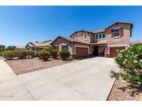 Charming two-story home with a well-manicured yard and a long driveway to two-car garage at 868 W Desert Glen Dr, San Tan Valley, AZ 85143