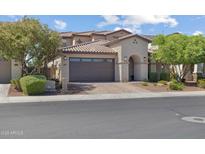 Beautiful home features a desert landscape, tile roof, paver driveway and spacious two car garage at 10071 W Angels Ln, Peoria, AZ 85383