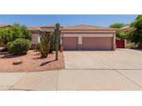 Charming single-story home featuring a two-car garage and desert landscaping with mature cactus and shrubs at 115 E Spur Ave, Gilbert, AZ 85296