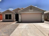 Charming single-story home featuring a two-car garage, low maintenance desert landscaping, and a welcoming facade at 1339 W Mesquite Ave, Apache Junction, AZ 85120
