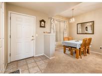 Inviting dining area featuring a wood table with four chairs and a neutral color palette at 14950 W Mountain View Blvd # 5306, Surprise, AZ 85374