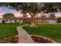Charming single-story home with lush lawn, brick walkway, and mature shade tree at 1831 E Rovey Ave, Phoenix, AZ 85016