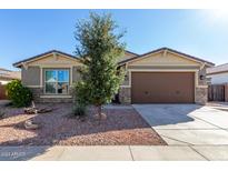 Charming single-story home featuring a well-maintained landscape and a two-car garage at 18581 W College Dr, Goodyear, AZ 85395