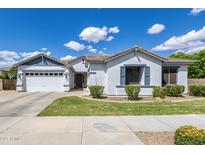 Charming single-story home with a well-manicured lawn and a two-car garage under a beautiful blue sky at 19160 E Canary Way, Queen Creek, AZ 85142