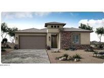 Charming single-story home featuring a stone facade, desert landscaping, and a two-car garage at 20025 W Campbell Ave, Buckeye, AZ 85396