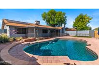 Inviting backyard with a refreshing pool and lush landscaping, perfect for outdoor relaxation at 2114 E Sesame St, Tempe, AZ 85283