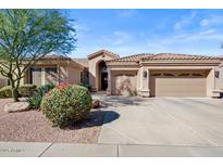 Charming single-story home with a well-manicured yard, three-car garage, and lovely desert landscaping at 22634 N 47Th Pl, Phoenix, AZ 85050