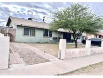 Charming single story home featuring a well-sized yard and large mature tree, complete with a paved walkway at 2310 N 40Th Dr, Phoenix, AZ 85009