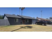 Charming single-story home featuring a gray exterior, well-manicured lawn, and attached garage at 2602 W Fremont Dr, Tempe, AZ 85282