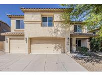 Inviting two-story home featuring a neutral color palette, three-car garage, and well-maintained landscaping at 28054 N Jade St, San Tan Valley, AZ 85143