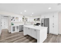 Bright modern kitchen with white cabinets, stainless steel appliances, and a large center island at 301 N 87Th St, Mesa, AZ 85207