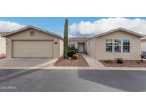 Inviting single-story home featuring low maintenance landscaping and an attached two-car garage at 3301 S Goldfield Rd # 1046, Apache Junction, AZ 85119