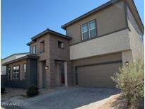 Two-story home featuring mixed brick and siding exterior and an attached two car garage at 359 N 157Th Ln, Goodyear, AZ 85338