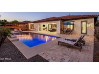 Inviting backyard pool and patio with lounge chairs for relaxing by the water at 4822 N Barranco Dr, Litchfield Park, AZ 85340