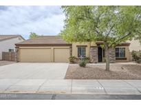 Charming single-story home with a three-car garage, stone accents, and mature landscaping at 637 E Settlers Trl, Casa Grande, AZ 85122