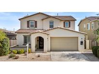 Charming two-story home featuring a neutral color palette and a spacious two-car garage at 9727 E Torino Ave, Mesa, AZ 85212
