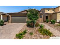 Charming single-Gathering home with a well-manicured front yard, paver driveway, and a two-car garage at , Avondale, AZ 85323
