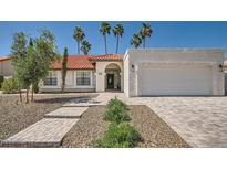 Charming single-story home featuring a red tile roof, landscaped yard, and a two-car garage at 10522 E Bella Vista Dr, Scottsdale, AZ 85258