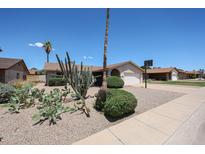 Charming single-level home with low maintenance desert landscaping and a two-car garage at 10858 E Sahuaro Dr, Scottsdale, AZ 85259